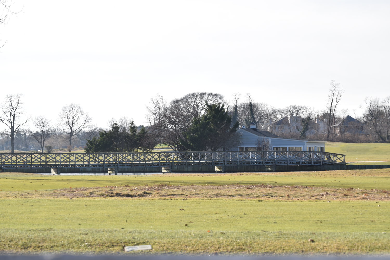 The Woodmere Club golf course lies dormant for the winter, but the legal wrangling goes on: Its owners have filed a second lawsuit, this one against the Village of Woodsburgh.
